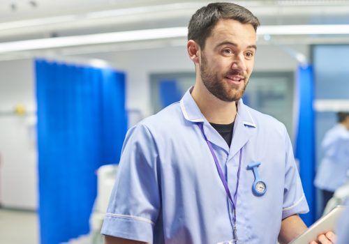 a male nurse catting to a colleague